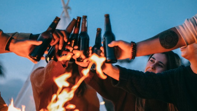 Beer bottles being raised