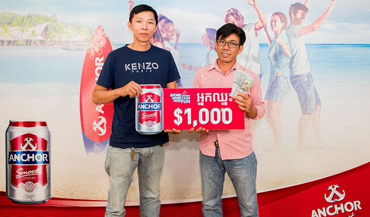 Anchor Beer ring pull winners in Cambodia collecting their $1000 prize