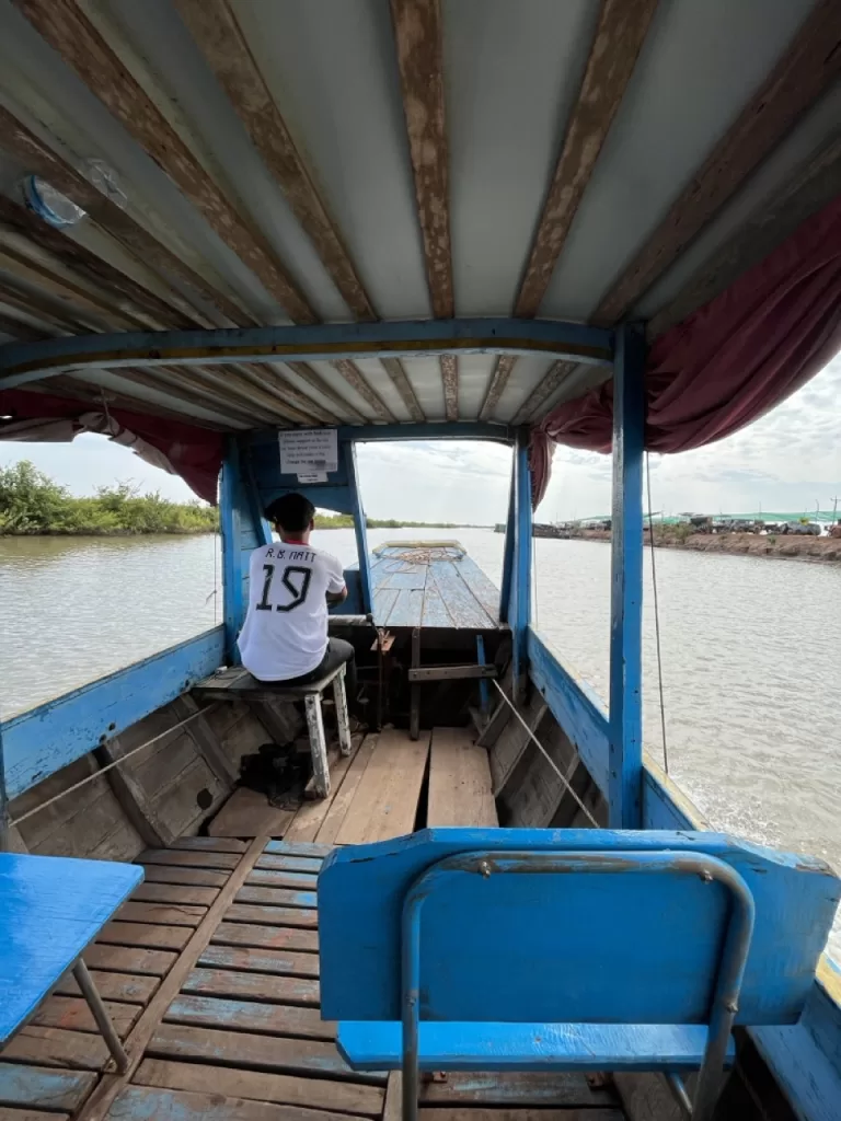 The driver of a small boat on the Tonle Sap Lake visiting the floating villages of Kompong Phluk