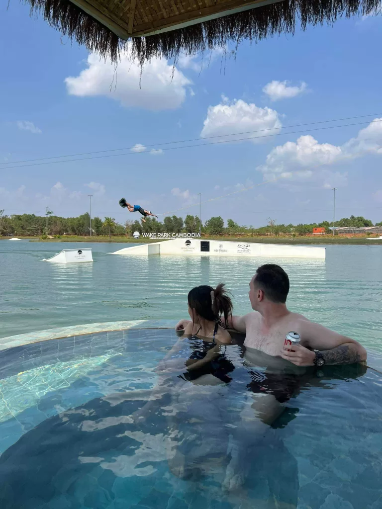 Watching the wakeboarding at Wake Park Cambodia from the private dipping pool