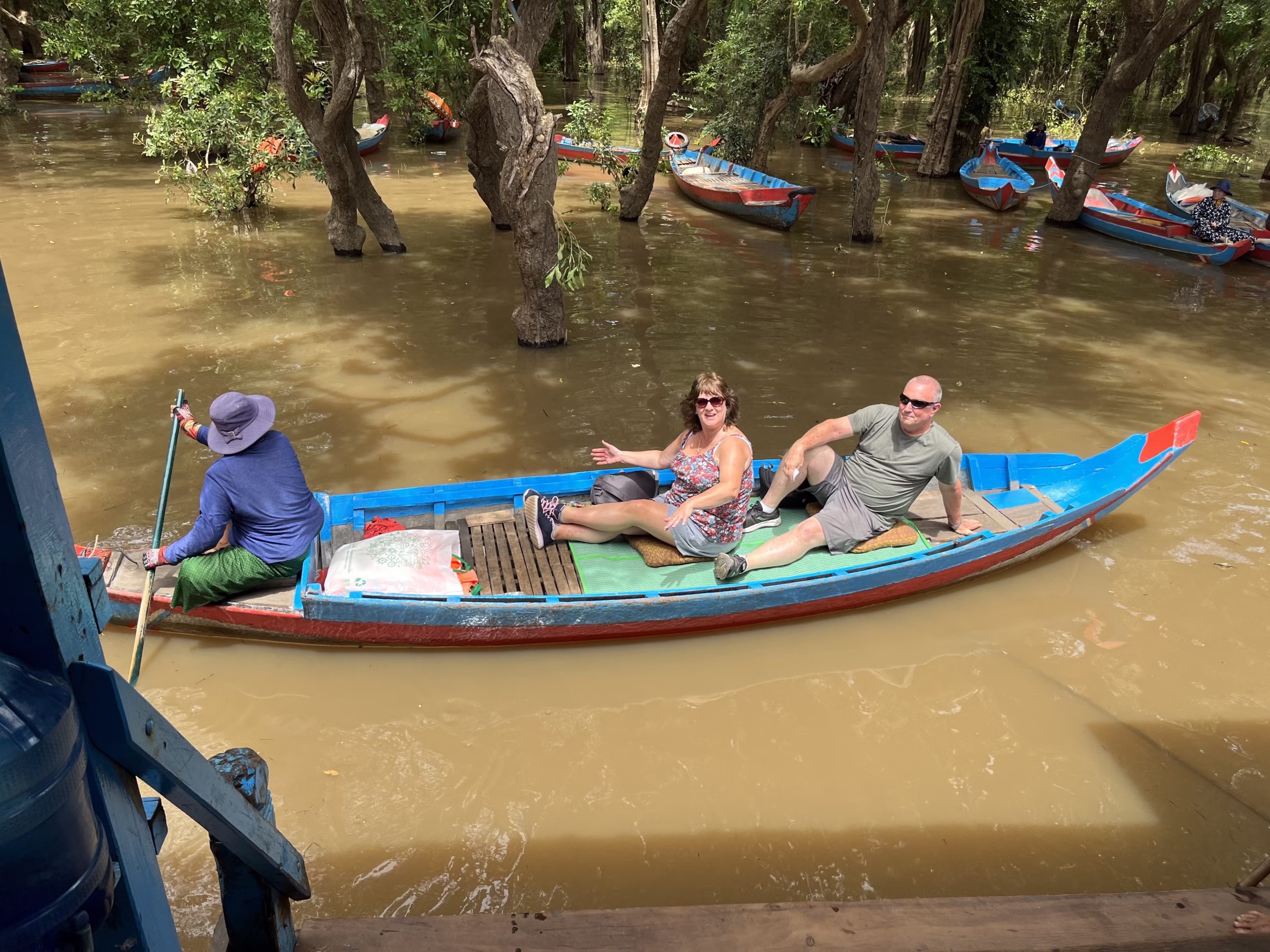 English Couple visiting the flooded forests of the floating villages Siem Reap Cambodia