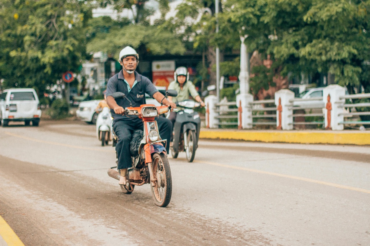 Cambodian man driving a scooter in Siem Reap